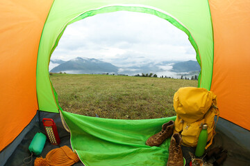 Wall Mural - Picturesque view of mountains from green tent