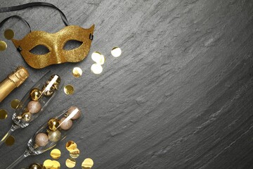 Canvas Print - Beautiful golden carnival mask, bottle of sparkling wine, glasses with decorative balls and confetti on gray textured table, flat lay. Space for text