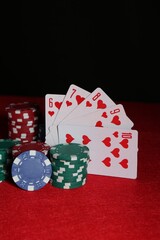 Wall Mural - Poker chips and playing cards on red table