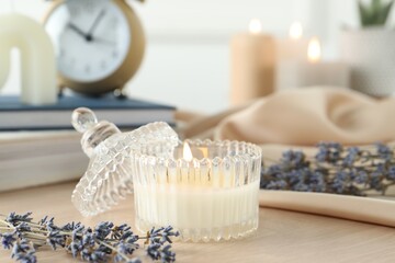 Wall Mural - Beautiful burning candle, flowers and decor on wooden table, closeup