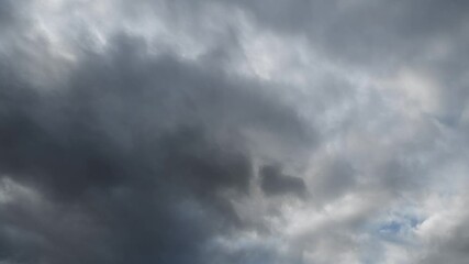 Wall Mural - time lapse looking up at grey storm clouds moving from left to right