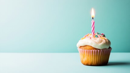 Birthday cupcake with one candle on pastel background