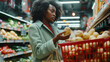 © Mutshino_Artwork - Young woman grocery shopping, selecting fresh produce in a supermarket aisle