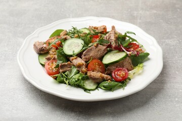 Delicious fresh tuna salad on grey table, closeup