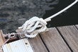 © Mariia - Mooring post, a mooring knot on a yacht pier. The yacht's mooring ropes are attached to the knecht. Knecht on the deck on the pier for fastening ropes. Knecht for mooring and fastening ropes