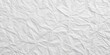 © Theerawat - A Detailed Texture of Crumpled White Paper, Exhibiting a Rough, Uneven Surface with Deep Creases and Folds