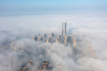 Aerial view of the city in the fog. Skyscrapers above the fog