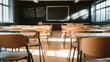 © BerkahStock - A classroom with empty desks and a blackboard, illuminated by natural light.