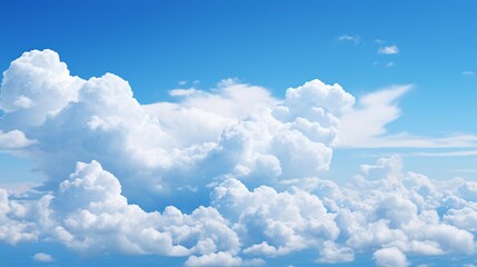 A panoramic shot of a blue sky with large, billowing clouds