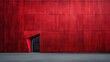 © Maximages  - A massive red wall with a small, angular entrance creates an imposing building facade, offering a stark contrast between the deep red and the minimalistic design.