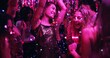© Nina2024/peopleimages.com - Women, dancing and glitter in night club for party, celebration and excited for New Year. Friends, movement and energy on dancefloor for event, disco or birthday social with neon lights for aesthetic