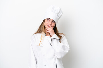 Wall Mural - Young caucasian chef woman isolated on white background having doubts and with confuse face expression