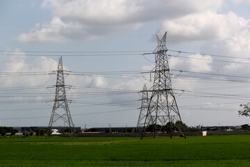 Powerline cables over the blue sky