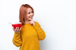 © luismolinero - Young Russian girl holding a bowl of cereales isolated on white background thinking an idea and looking side