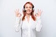 © luismolinero - Telemarketer Russian girl working with a headset isolated on white background in zen pose