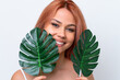 © luismolinero - Young Russian girl isolated on white background holding a palm leaf with happy expression. Close up portrait