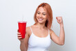 © luismolinero - Young Russian woman holding soft drink isolated on white background celebrating a victory