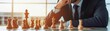 © Emma - Businessman contemplating a chess move on a desk close up, focus on, copy space, bright hues for clarity, double exposure silhouette with corporate meeting