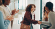 © KayExam/peopleimages.com - Employees, women and happy at office with handshake for recruitment, welcome and agreement. Business, people and smile or applause for job well done, promotion and career opportunity at meeting