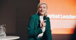 © KayExam/peopleimages.com - Mature woman, stage and leadership seminar for information, knowledge and public speaking. Female person, presentation and screen at global summit for business motivation, discussion and ideas