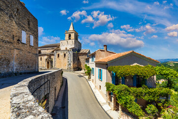 View of Venasque village with old church Notre Dame de Vie to landscape of Luberons, Provence, France. Beautiful Church and houses in the town of Venasque, Provence, France.