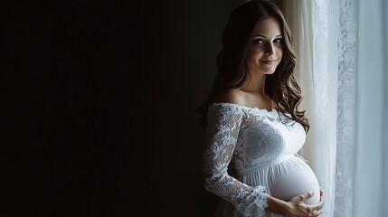 Canvas Print - Beautiful white pregnant woman stands at the window. Brunette pregnancy lady in white dress, holding hand on belly. Pregnancy banner 