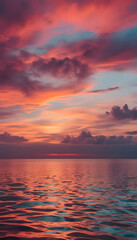 A stunning sunset over a calm ocean, with vibrant hues of orange, pink, and purple reflecting on the water's surface. The sky is filled with dramatic clouds, creating a serene and picturesque scene.