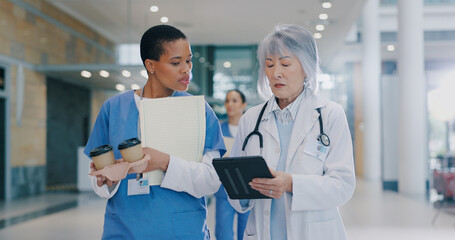 Wall Mural - Doctors, women and tablet for medical plan in hospital, coffee and walking to surgery with papers. People, clinic staff and online for healthcare treatment, talking and team for cardiology research