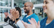 © LuxeShutter24/peopleimages.com - Medical team, people and smile at boardroom with applause for success, achievement and well done on promotion. Presentation, employees and happy on meeting in healthcare with clapping hands at office