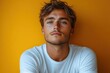 © Vesna - clean product mockup of young man wearing crisp white tshirt against vibrant yellow background highlighting simplicity and contemporary design