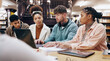 © LuxeShutter24/peopleimages.com - Education, laptop and study group with student friends at desk in library of university together for learning. Computer, development or diversity with men and women on college campus for scholarship