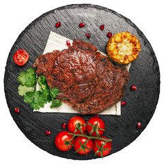 Wall Mural - grilled steak with vegetables on a slate board isolated on white background. top view clipping path. top view