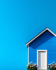 A charming blue house with a white door and blooming flowers, set against a vibrant blue backdrop, ideal for real estate or home themes.