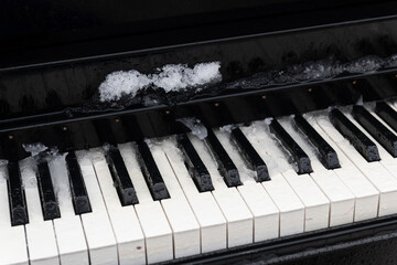 Remnants of an ice storm on the keys of a grand piano placed in a  public park in Jerusalem.