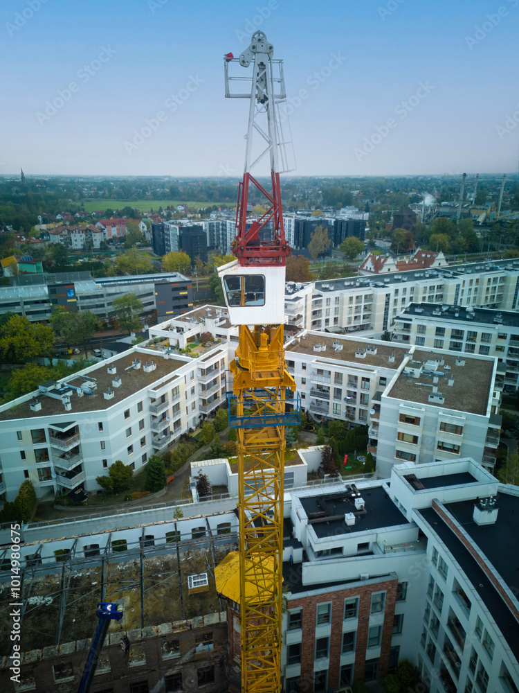 Aerial view of a tower crane with a rotating mechanism on top, being ...