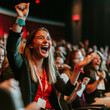 © cinta - Joyful Audience Reaction: Woman celebrates excitedly at a conference or event, surrounded by a cheering crowd.  A vibrant image capturing the energy and enthusiasm of a live audience.