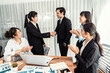 © InfiniteFlow - Group of businesspeople shake hand after made successful business agreement meeting. Diverse race office worker celebrate after made progress on marketing planning in corporate office. Meticulous