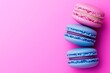 © Nataliia_Trushchenko - Pink and blue macaron is on a white plate. There are three other pink macarons on the plate. food photography , clean background in pastel colors, freestyle composition, fresh and whimsical