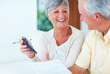 © STEEXBuyout/peopleimages.com - Senior, couple and finance paperwork with calculator on sofa for budget planning, asset management or mortgage payment. Mature, people and laugh in home with documents for investment account or bills