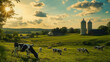 © Alina Tymofieieva - Cows grazing peacefully in a lush green field at sunset near a traditional farmhouse and silos in the countryside