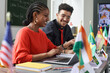 © Mediaphotos - Two young students man and woman working on project together in multicultural school classroom, copy space