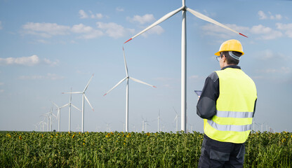 Aufkleber - Engineer with tablet computer on a background of wind turbine