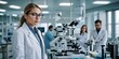 © kapatata - A young woman wearing a white lab coat and glasses, standing in a clinical setting with a blurred background, possibly a doctor or scientist.