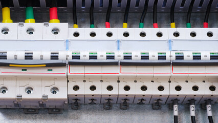 Wall Mural - A close up of a power box with many wires and outlets. The box is white and has a red stripe