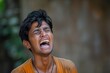 © Viktor - Young man with dark hair, contorted face, vibrant orange shirt. Expression of intense emotion, shock, pain, surprise. Central figure, blurred background, focused on face. Muted tones, contrast with
