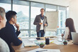 © CamPen2000/peopleimages.com - Businessman, team and meeting with whiteboard for presentation on corporate performance or statistics at office. Man, group or employees listening to coach for graph, chart or data at conference