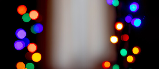 Wall Mural - bright bokeh on a black background with a light insert in the middle