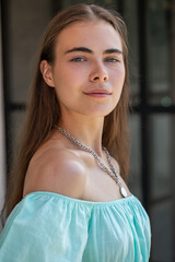 Canvas Print - Young beautiful woman in a summer turquoise dress