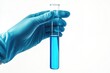 © iridescentstreet - A lab technician holds a test tube filled with blue liquid under bright lighting for scientific analysis in a laboratory setting