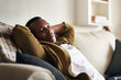 © Malambo/peopleimages.com - Black man, sleeping and couch for rest in home, peace and comfortable living room for dreaming. Male person, lazy weekend and chilling on sofa to relax, nap and tired guy in apartment for break